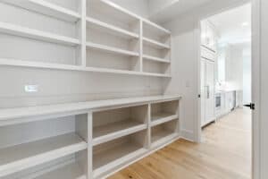 Built-in white shelving unit for kitchen storage and organization.